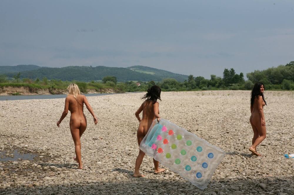 Naturist Park Floating On River photos - Nudity is seen as a natural part of life among nudists